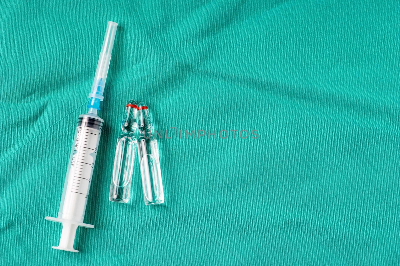 Medical Stethoscope lying on the hospital's green background. The background can be a textile part of a doctor or nurse's work uniform