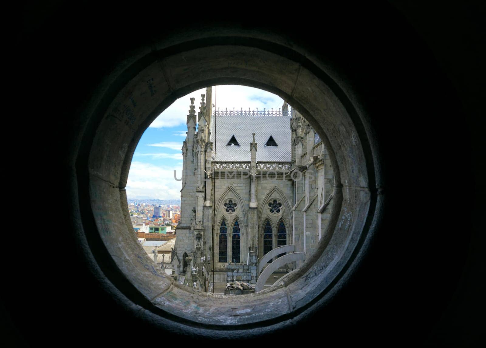 View of the Basilica of the National Vow in Quito, Ecuador as seen from a small round window