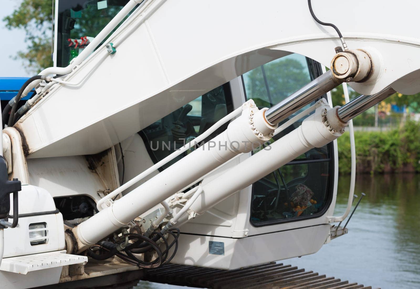 closeup of a pair of hydraulic cylinders of an excavator