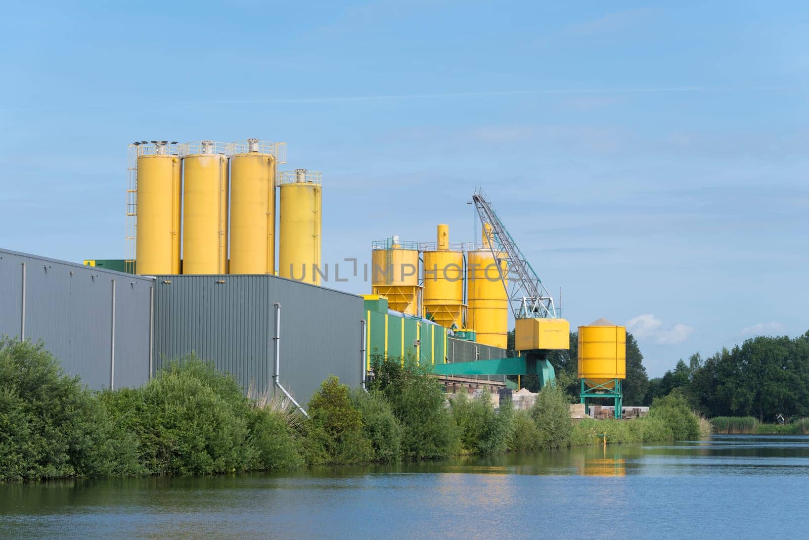 yellow silos belonging to a cement factory in the netherlands