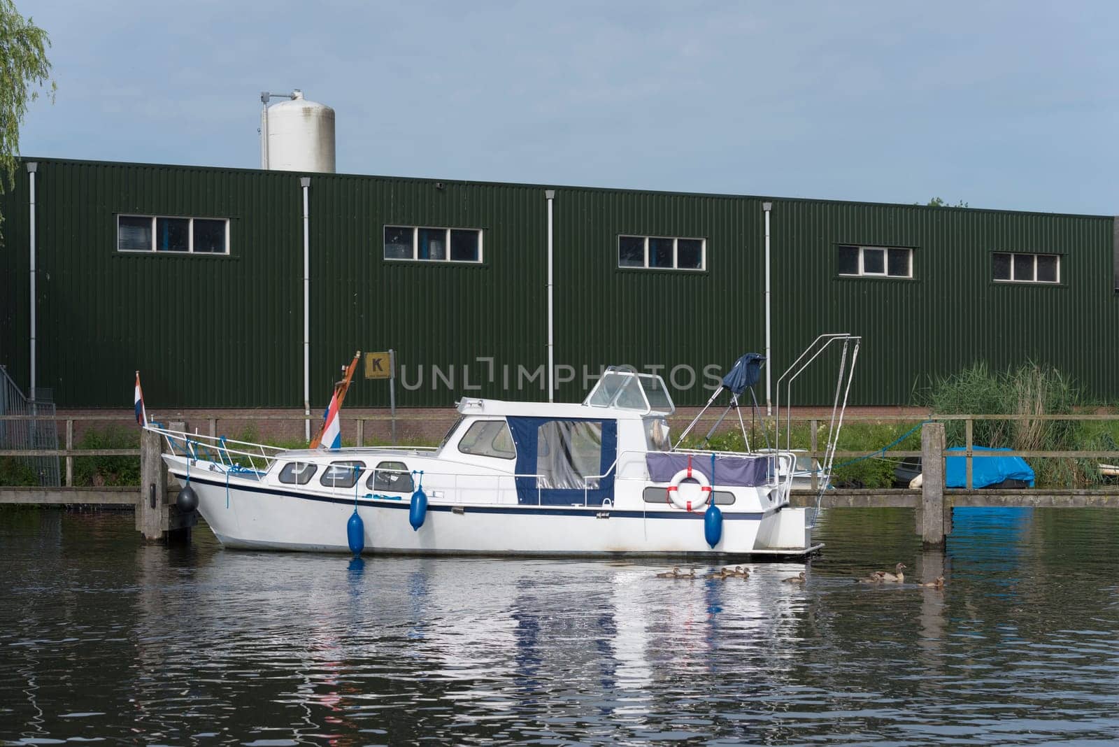 white yacht in the almelo harbor in the netherlands