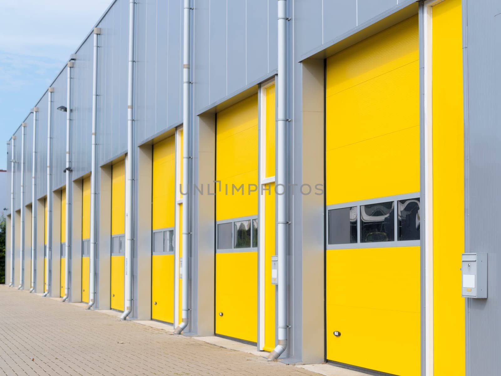 exterior of a commercial warehouse with yellow roller doors