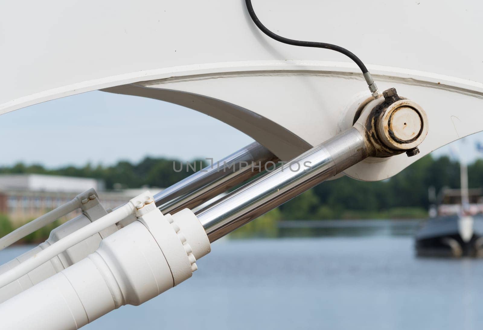 closeup of a pair of hydraulic cylinders of an excavator
