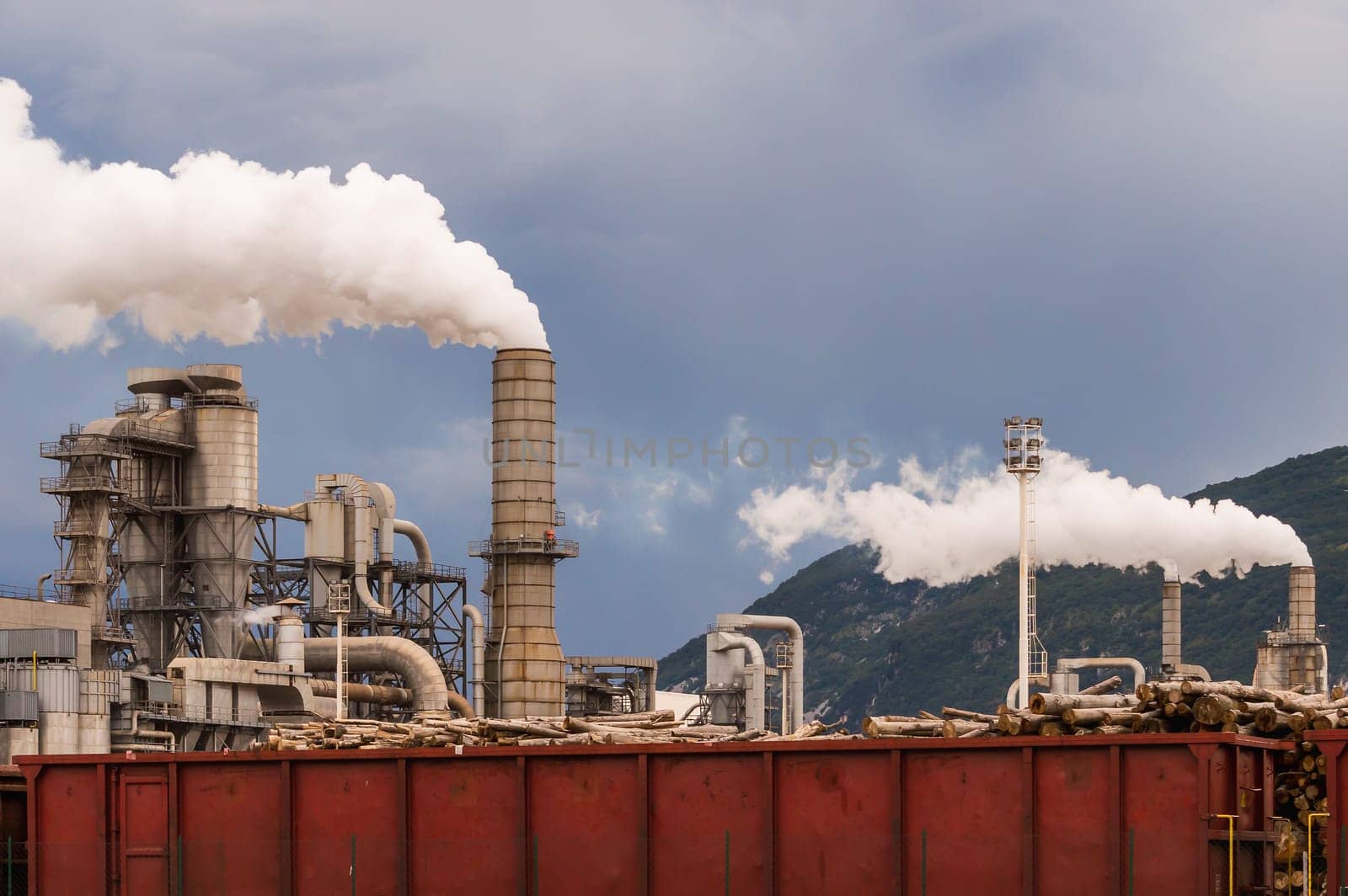 Industrial plant. Smokestacks ,storage tanks and rail wagon. Lumber industry