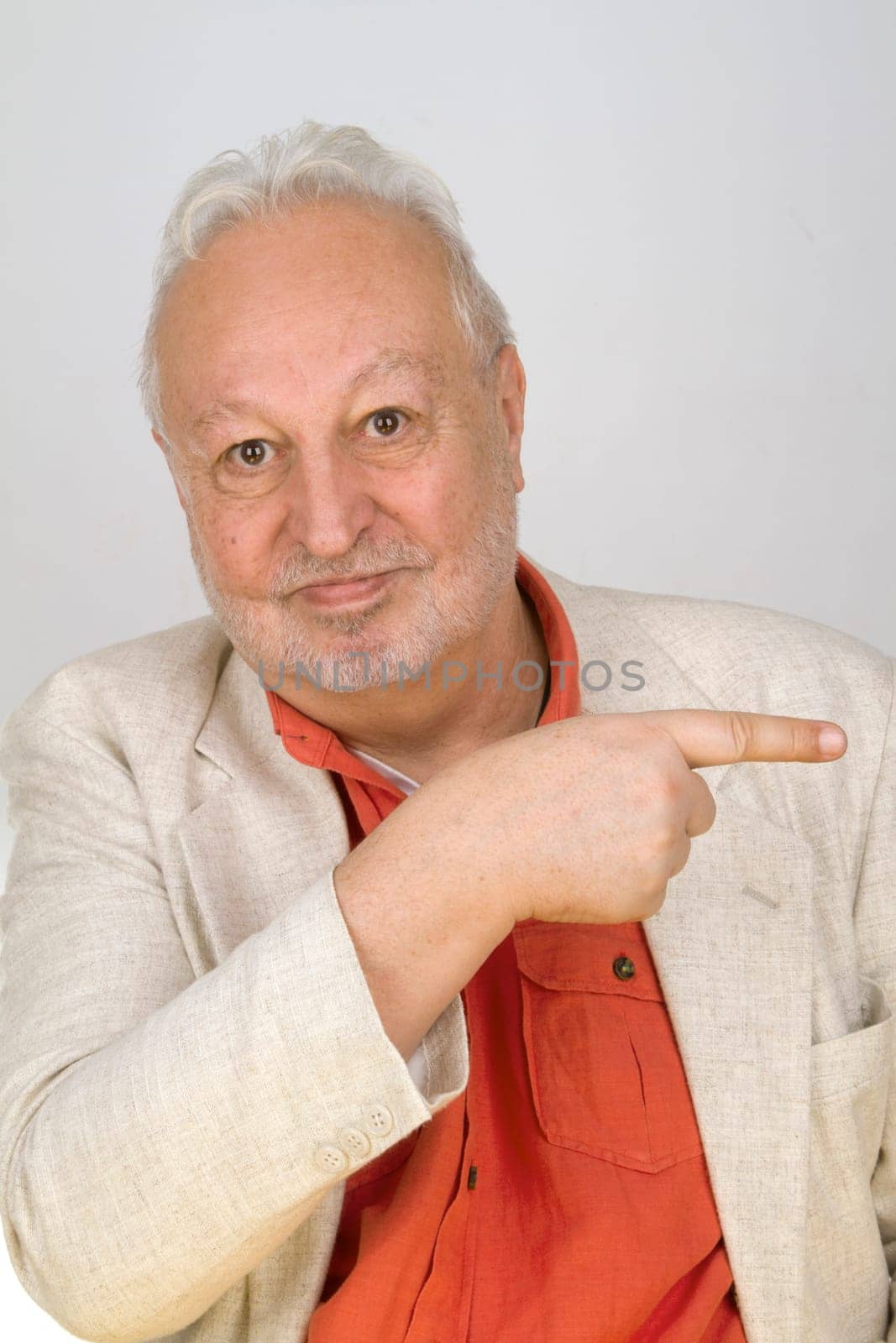 Senior points his finger on a light background