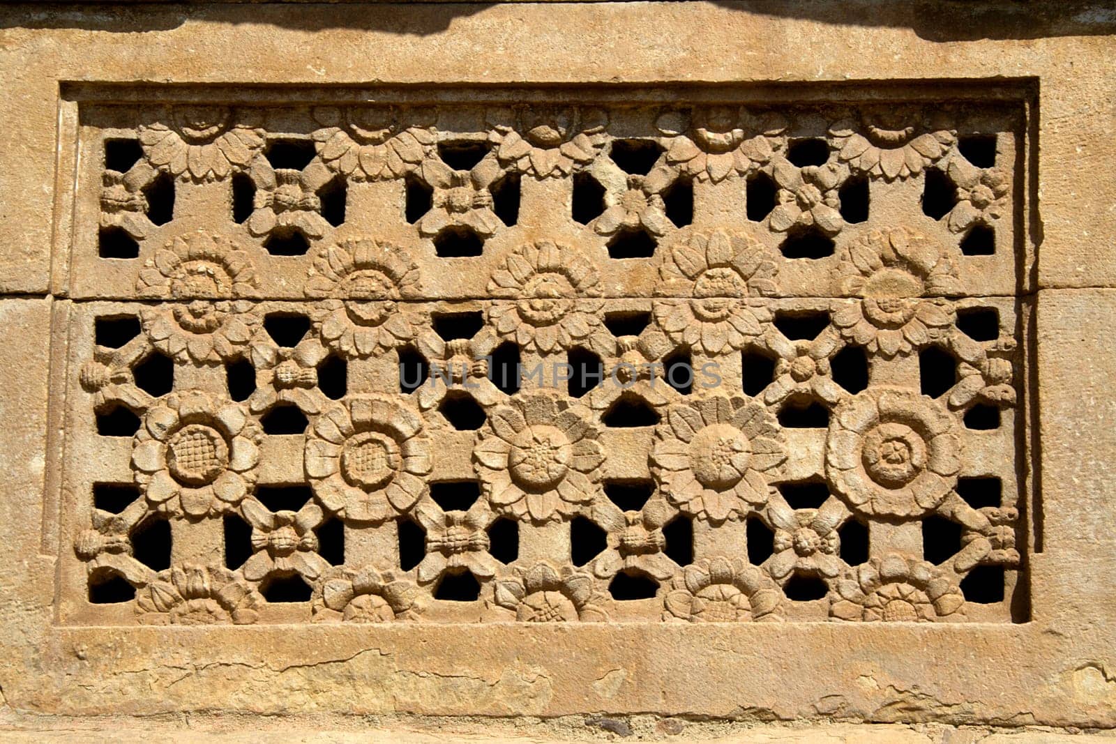 Artistically carved flower petals on stone window at Ladakhan Temple in Aihole, Bagalkot District, Karnataka, India, Asia