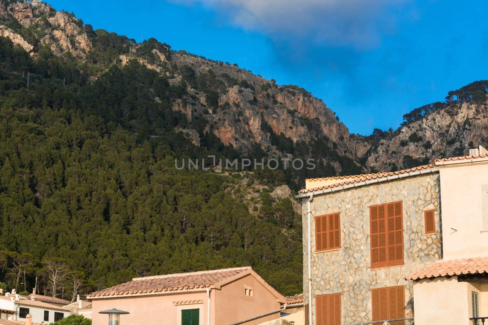 View from the port of Valldemossa to the mountains with the narrow access road. .