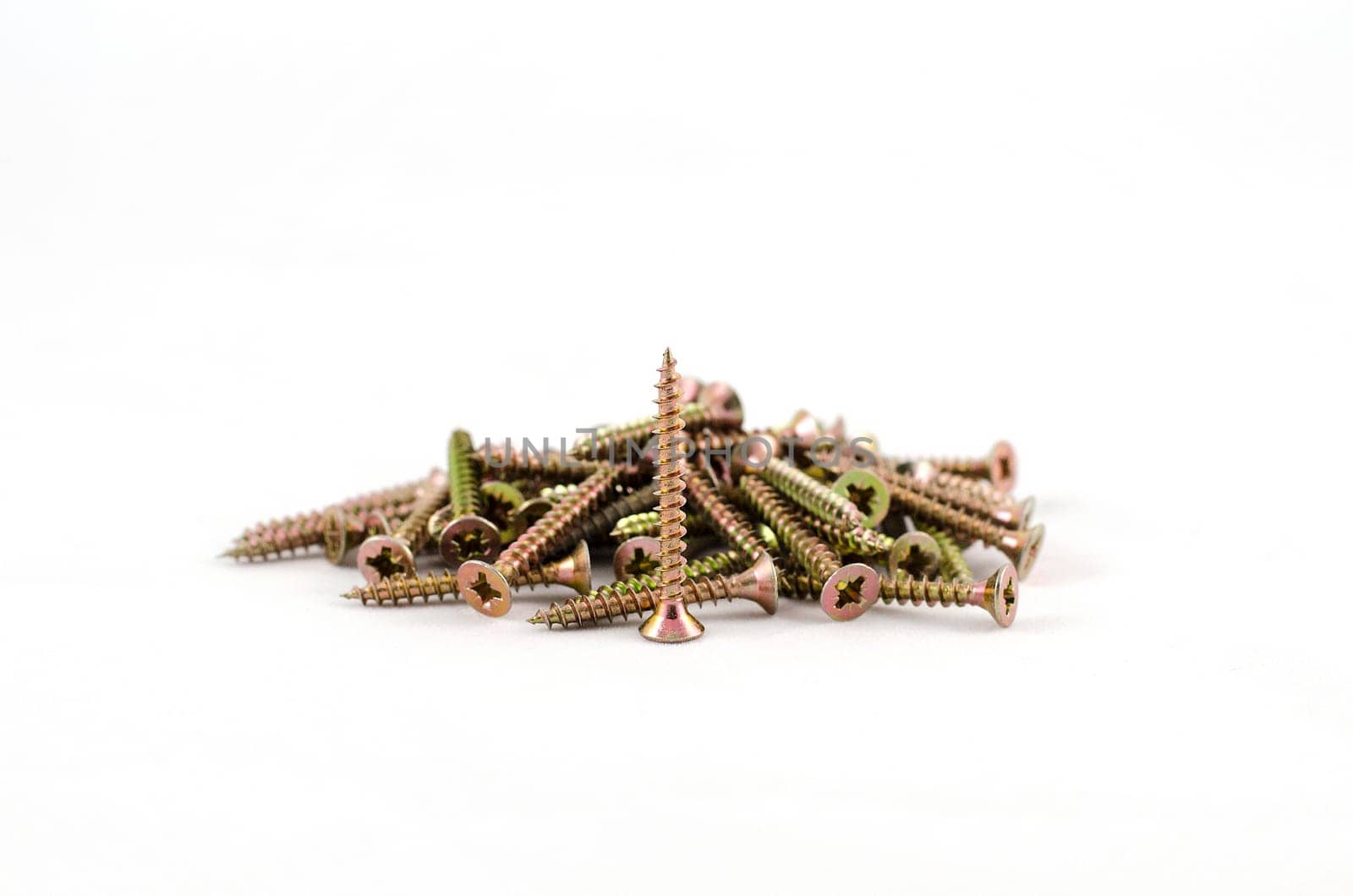 Zinked and anodized screws frame. Close-up. Macro.