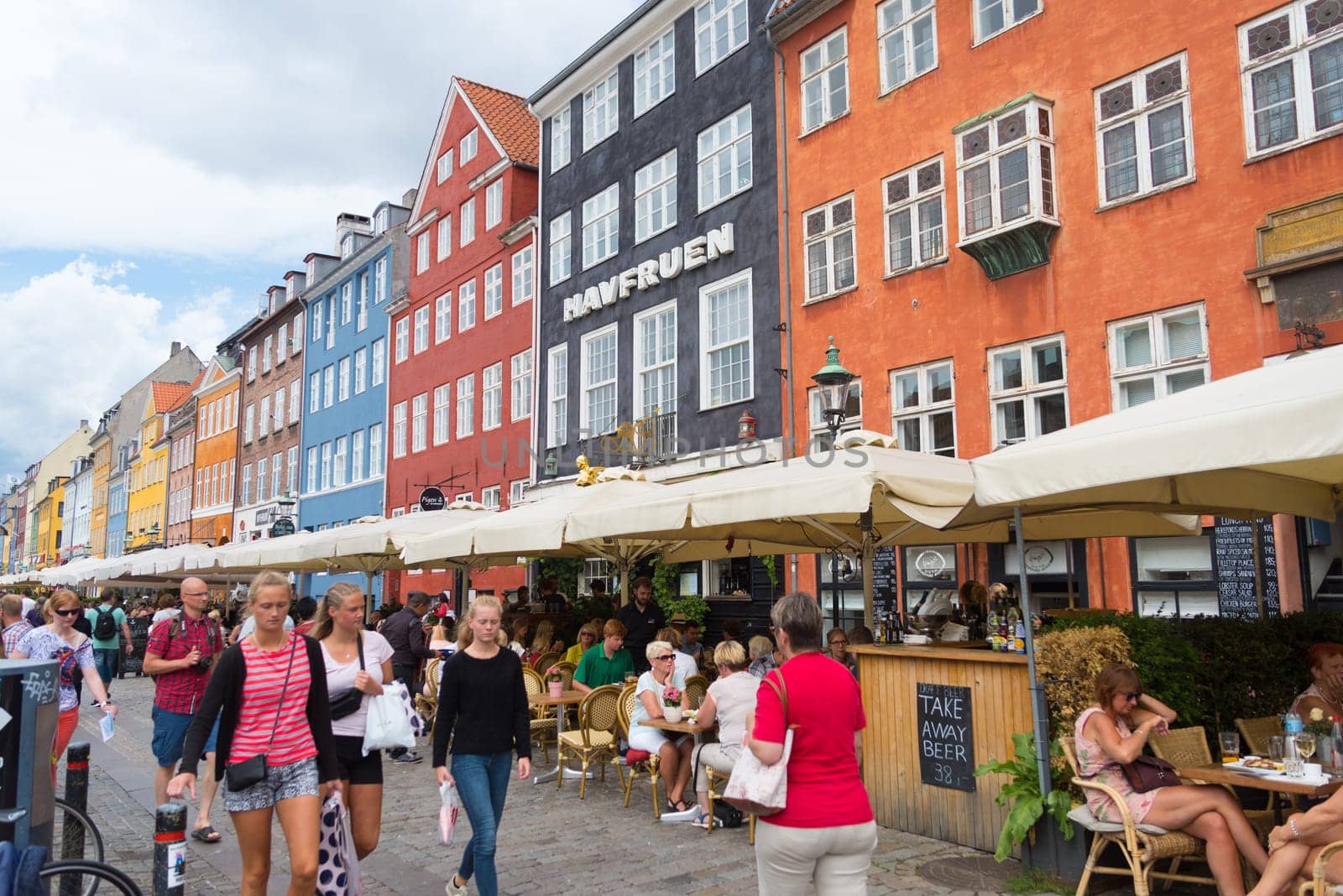 COPENHAGEN, DENMARK - JULY 31, 2016: Famous Nyhavn promenade with its colorful buildings. It is one of the most famous landmarks in the country