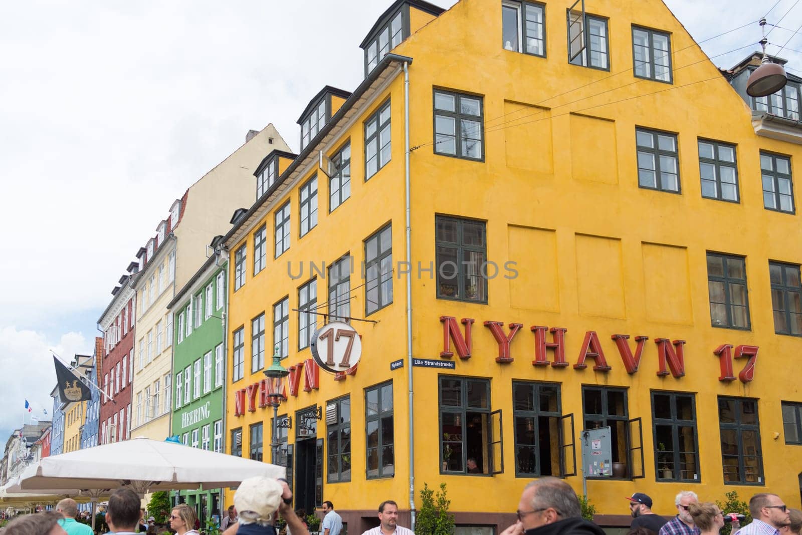 COPENHAGEN, DENMARK - JULY 31, 2016: Famous Nyhavn promenade with its colorful buildings. It is one of the most famous landmarks in the country