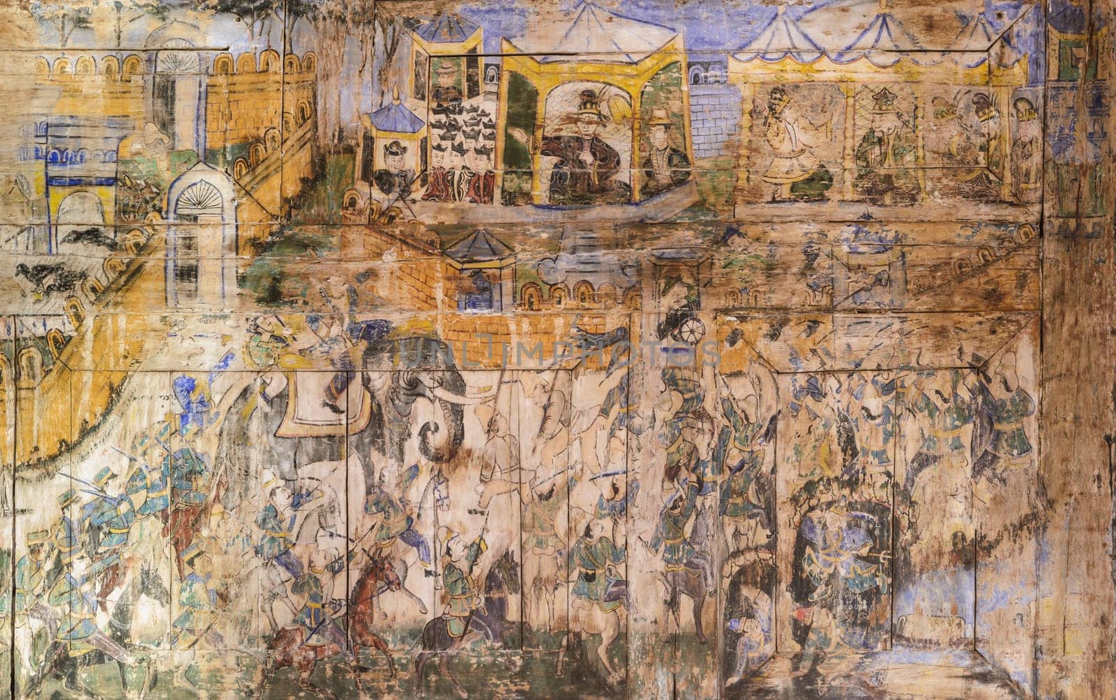 Ancient Thai mural painting on wooden temple wall in Lampang, Thailand