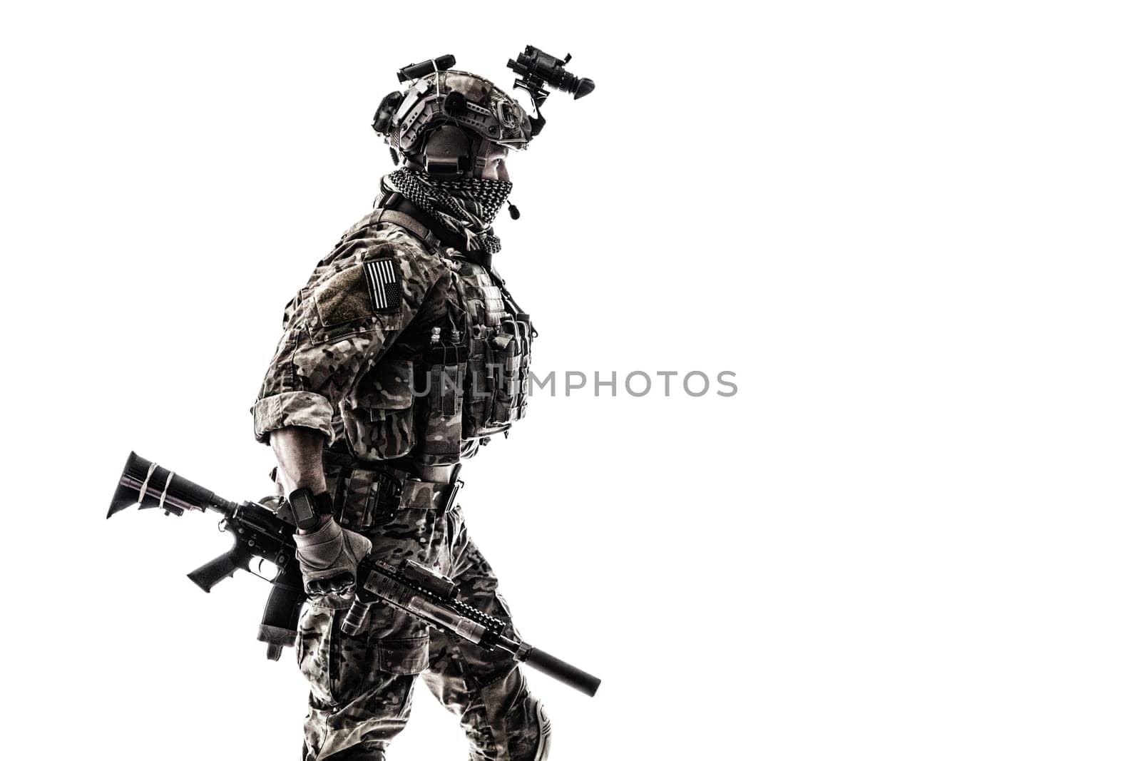 Army Ranger in field Uniforms with weapon, plate carrier and combat helmet are on, his face closed by Shemagh Kufiya scarf. Studio shot