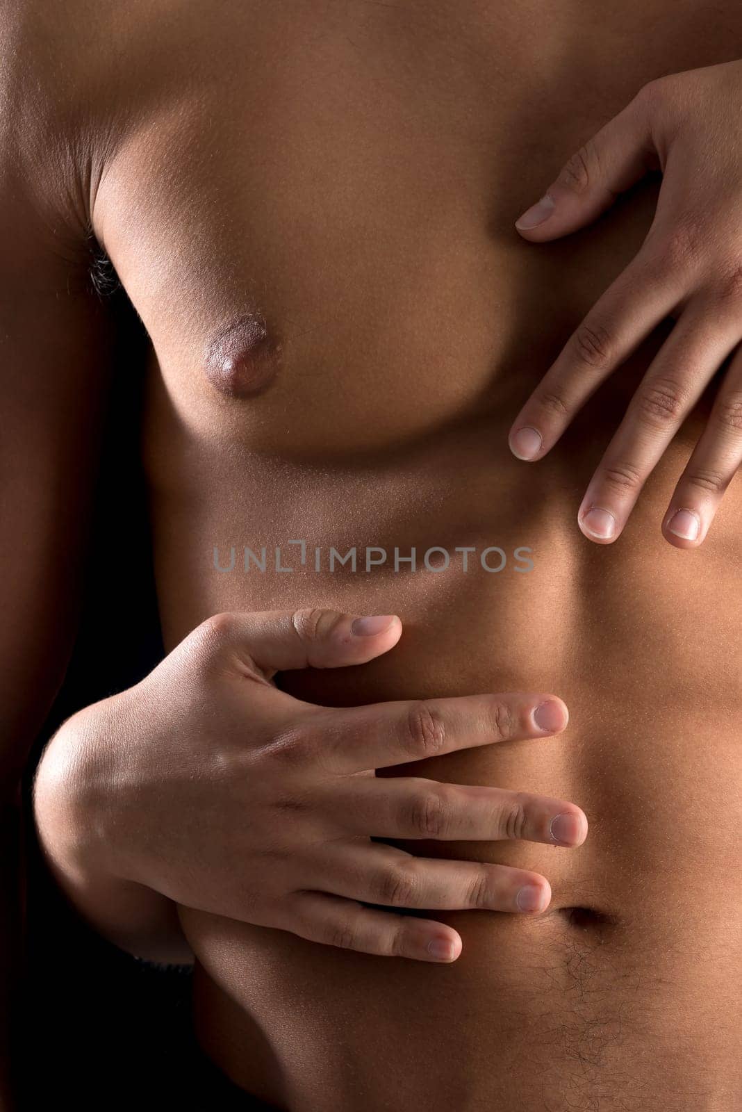 Ma's torso with woman's hands around isolated in black
