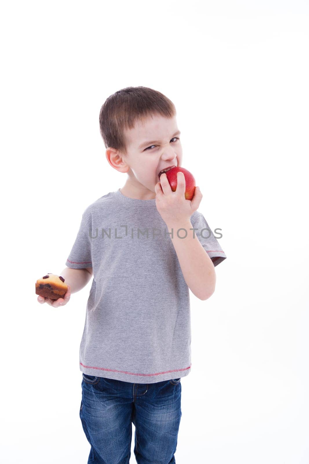 little boy with food isolated on white background - apple or a muffin