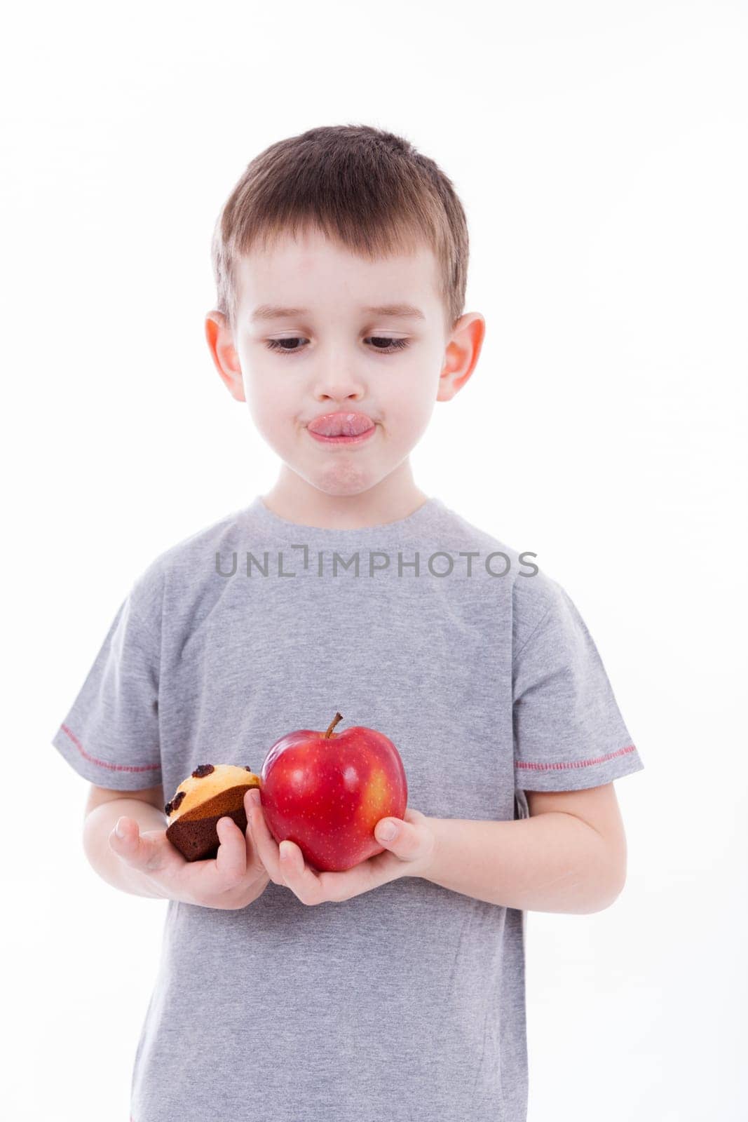 little boy with food isolated on white background - apple or a muffin
