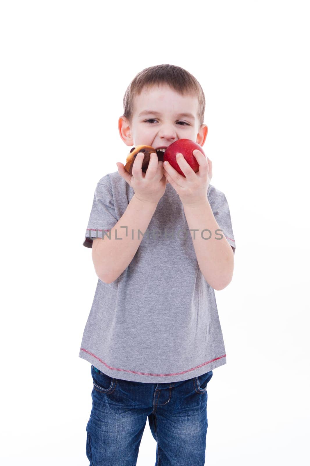 little boy with food isolated on white background - apple or a muffin