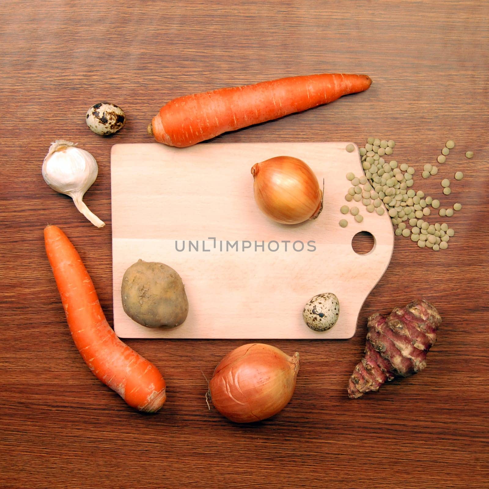 Cutting board with different vegetables on wooden background.