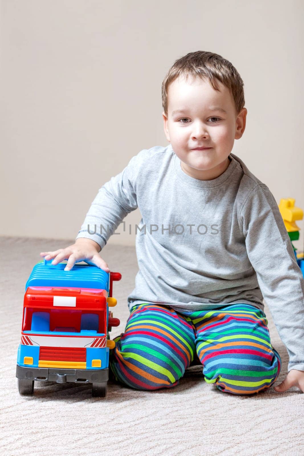 Playing little boy with colored cubes