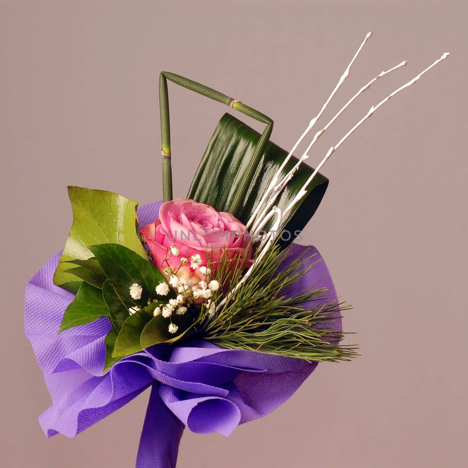 Bouquet with pink rose on gray background.
