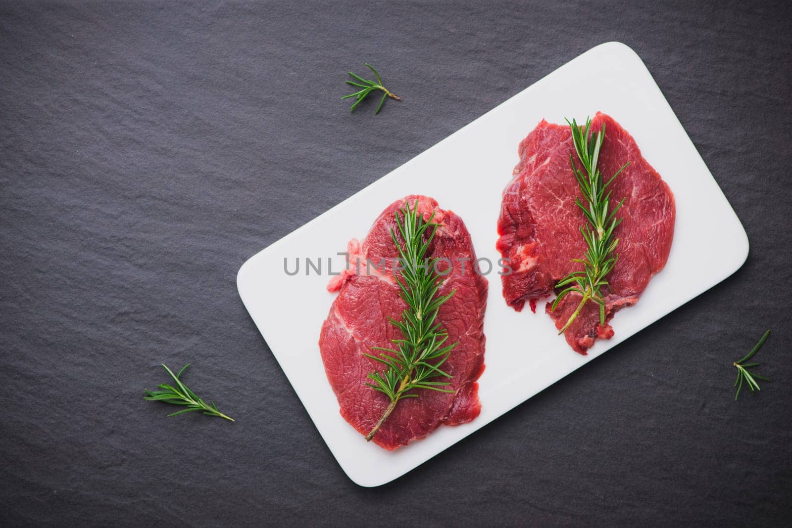 Raw beef meat sliced on a plate