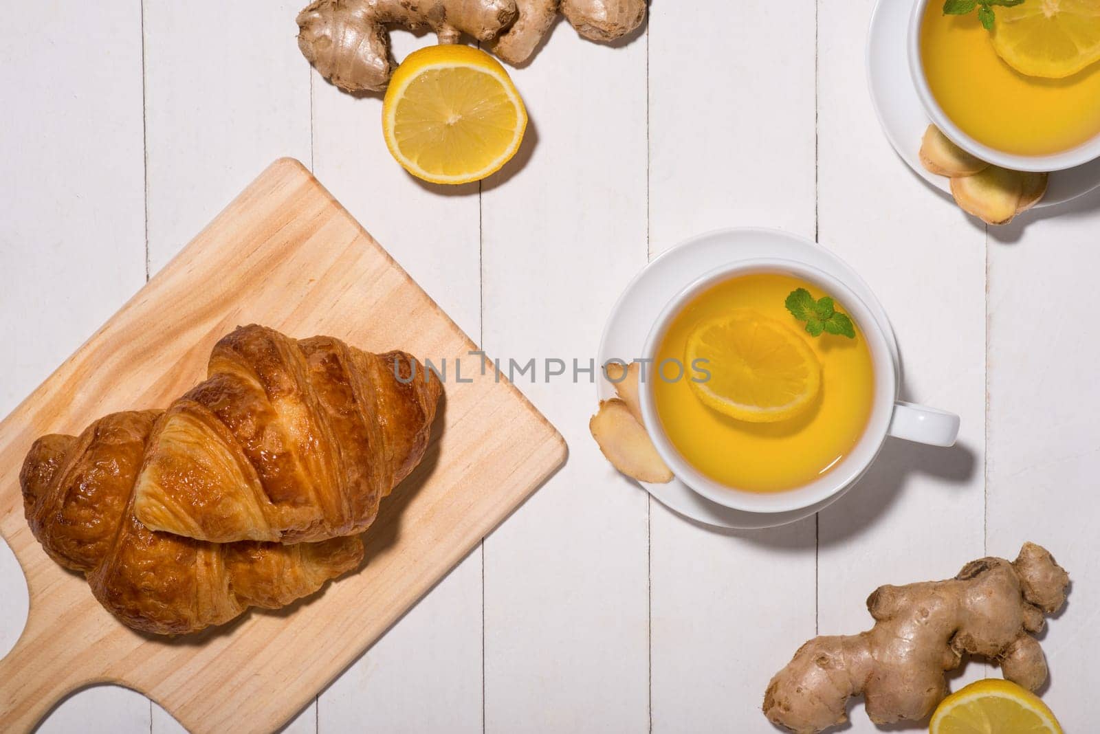 Healthy ginger tea with morning breakfast on a wooden table