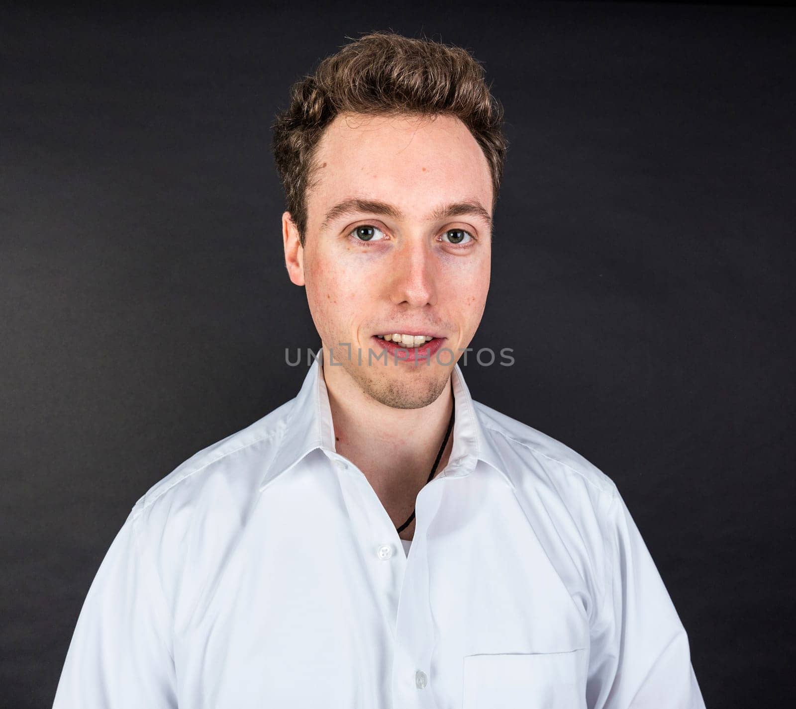 cute smiling teenage boy looks happy and confident