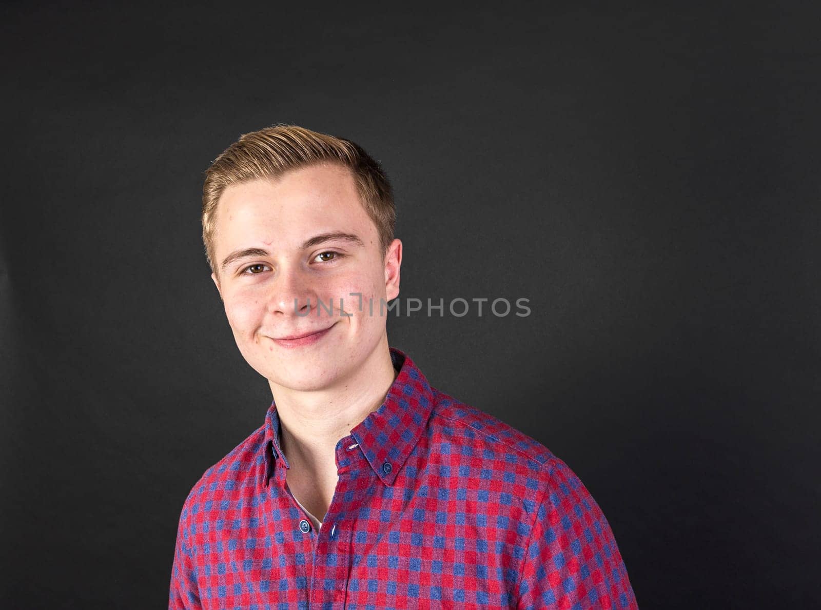 cute smiling teenage boy looks happy and confident