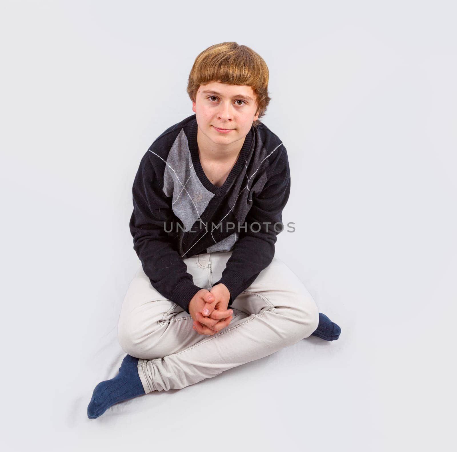 smart happy young boy posing in studio