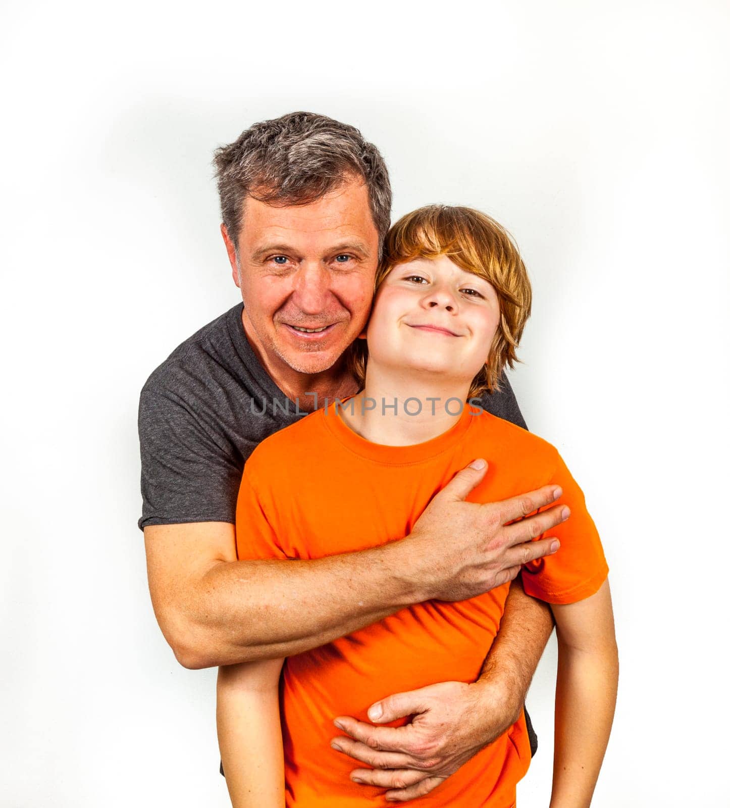 father and son hugging in studio isolated on white