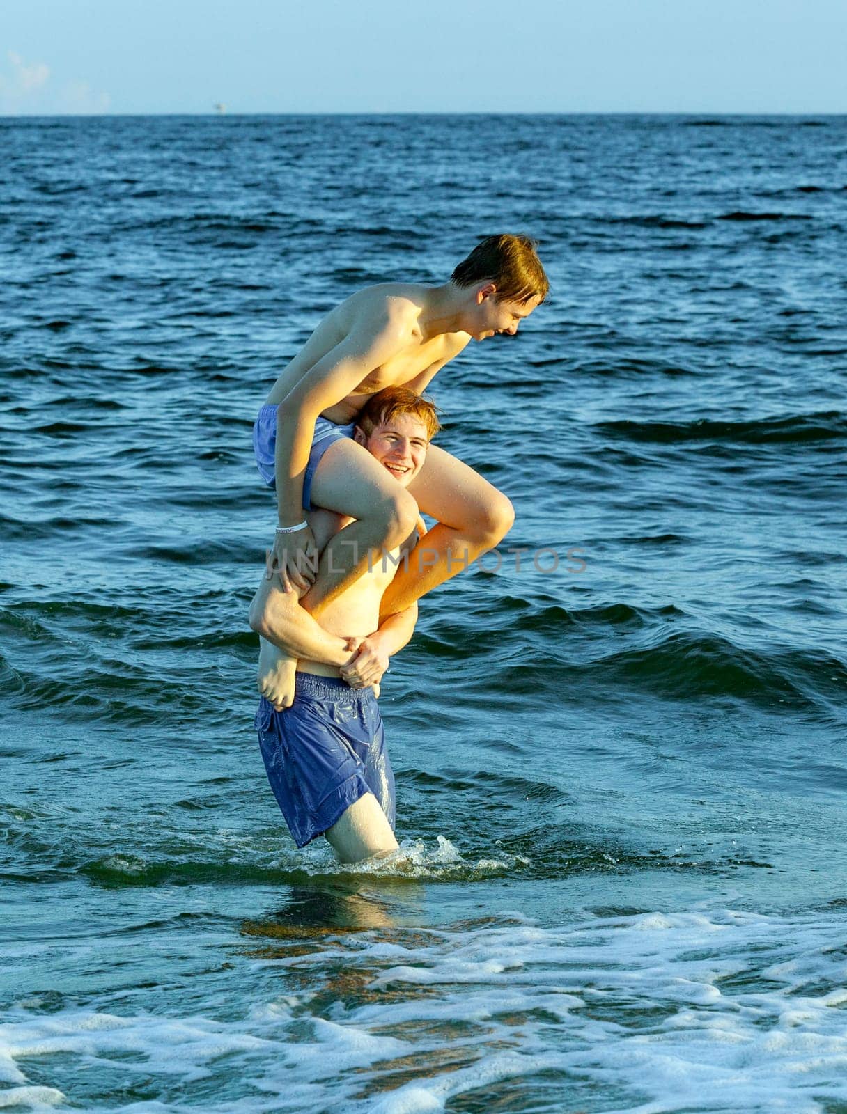 boys enjoy the beautiful beach in late afternoon  at Dauphin Islands