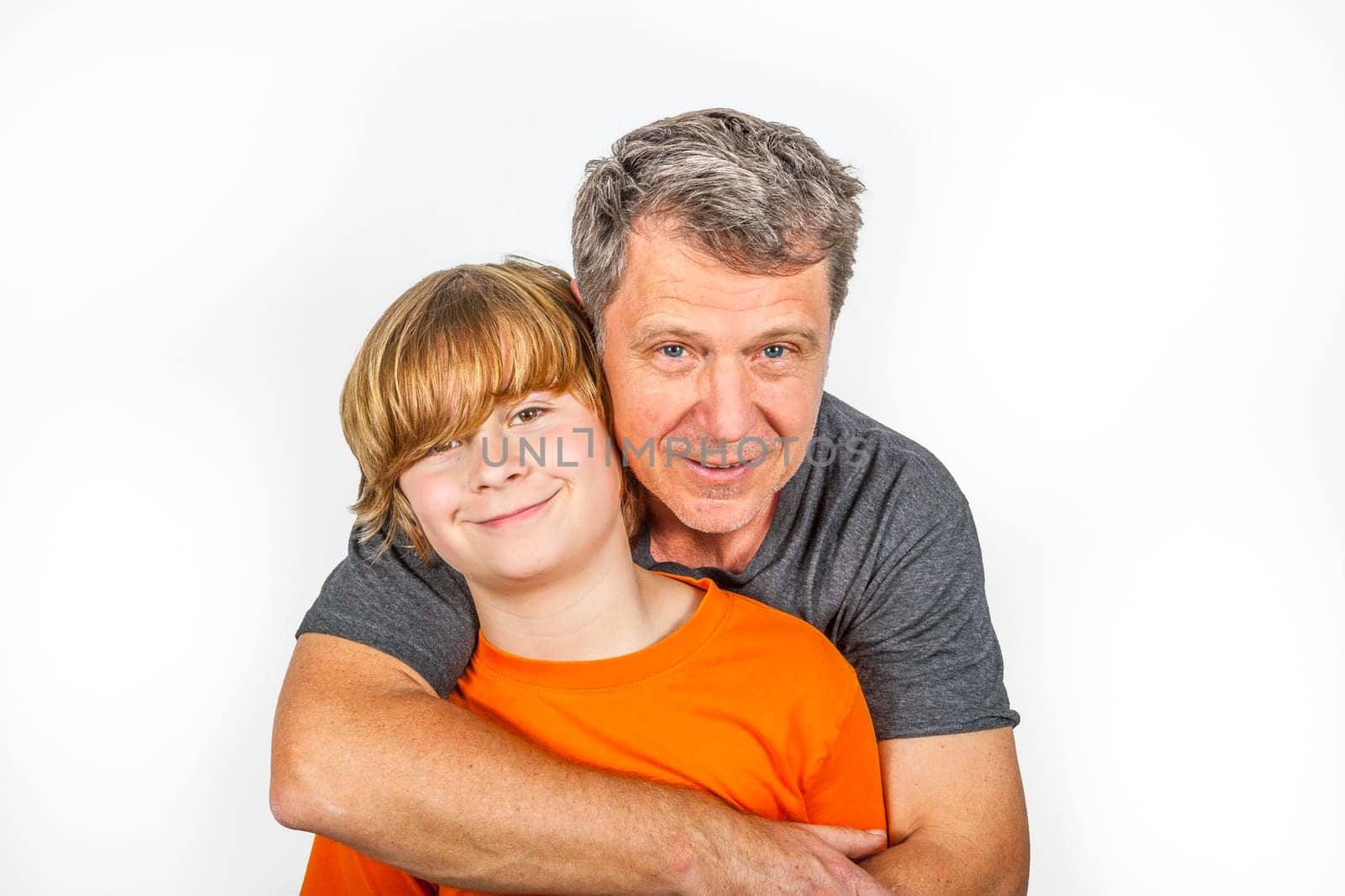 father and son hugging in studio isolated on white