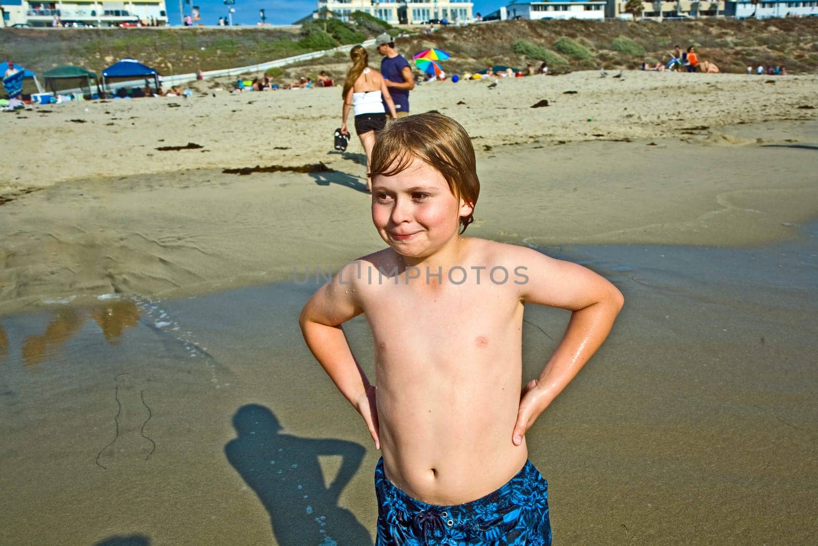 cute happy smiling boy enjoys the beach in California