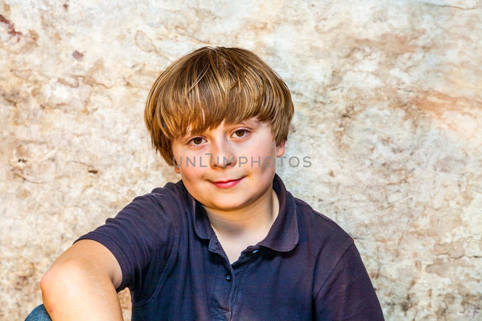 boy in the  cellar with a spotlight and an old brick wall
