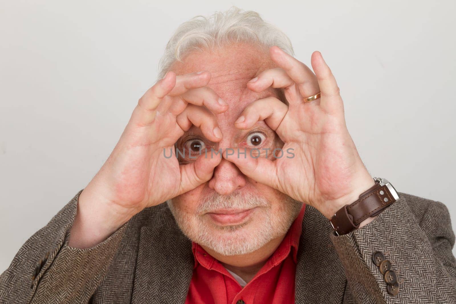 Senior holds fingers around his eyes - symbolism for the future and vision