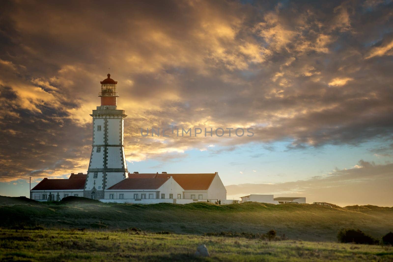 Beautiful Cabo Espichel lighthouse in Portugal, by sunset