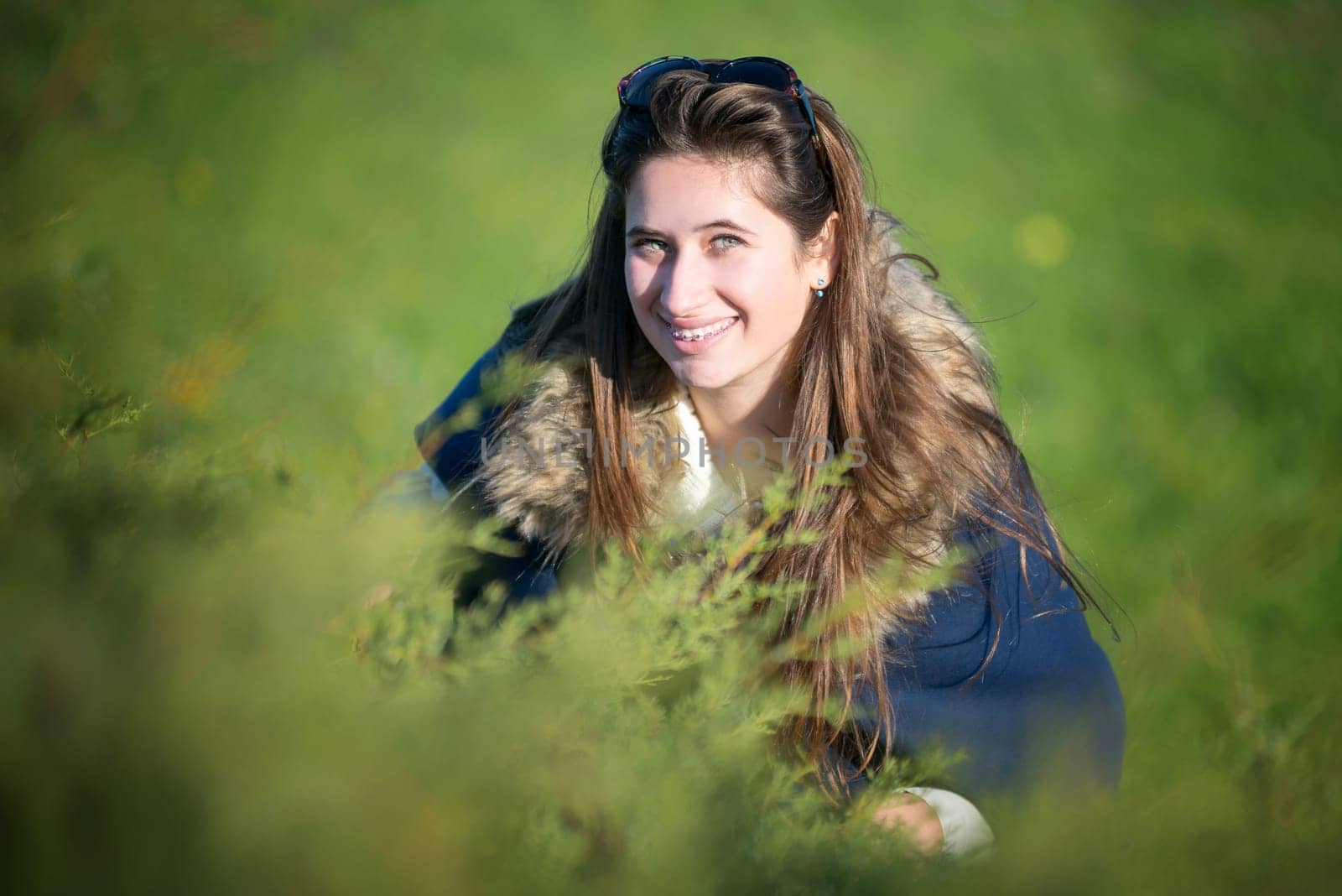 Beautiful and happy young girl posing outdoors