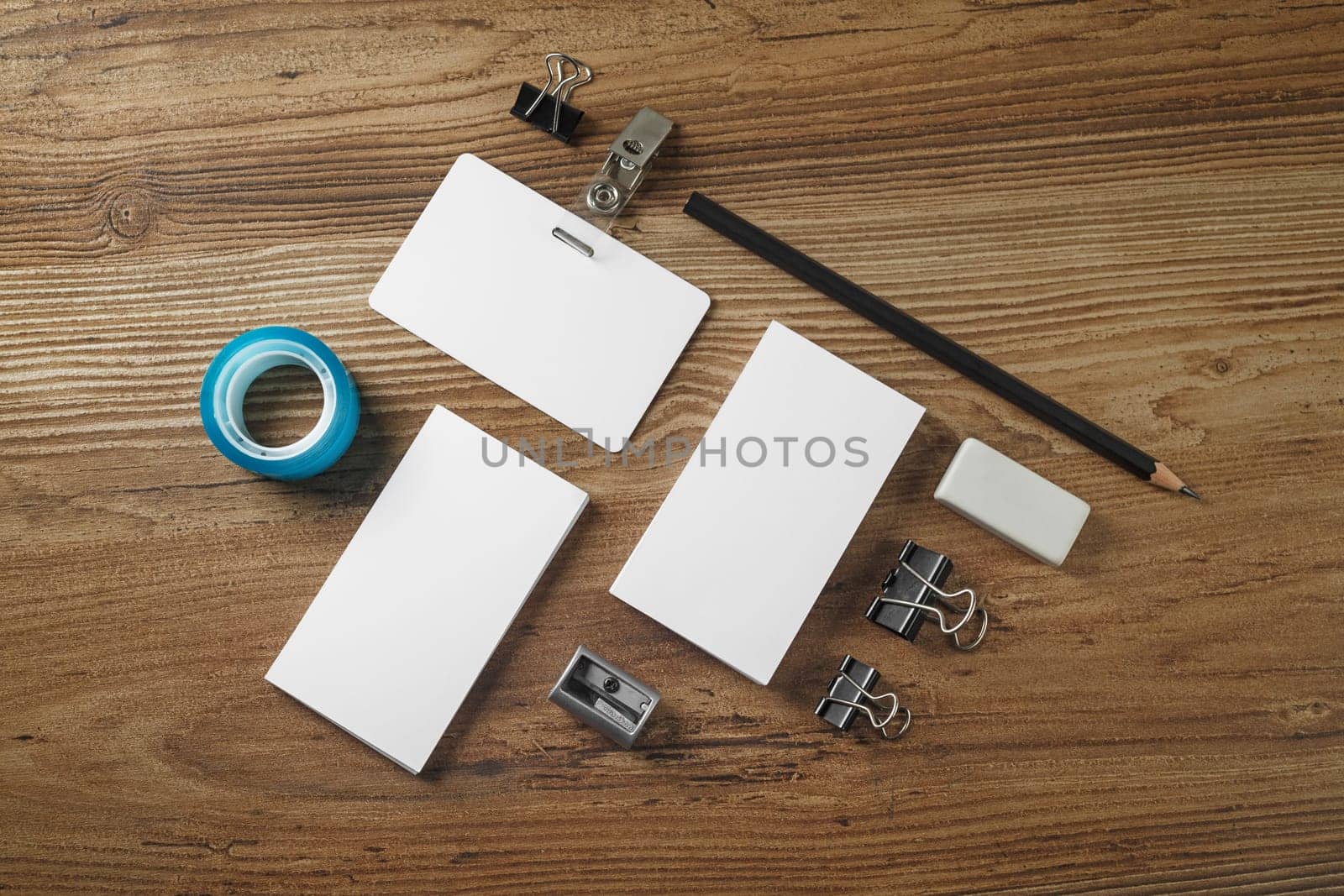 Blank corporate identity template on wooden table background. Photo of blank stationery. Mock up for design portfolios. Top view.