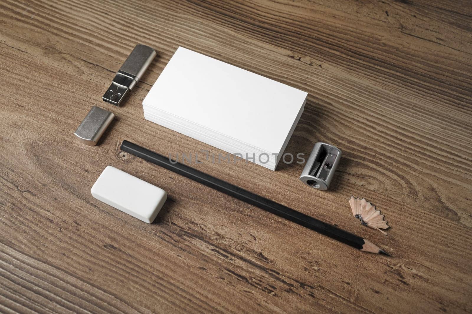 Blank stationery set. ID template. Mockup for branding identity. Bank business cards, pencil, eraser, flash drive and sharpener on wooden table background.