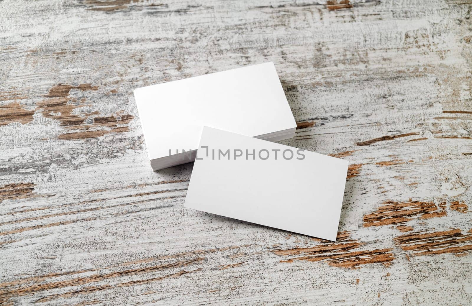 Photo of blank business cards on vintage wooden floor background. Template for your design.