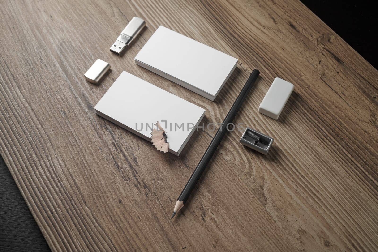 Mockup for ID. Template for branding identity. Bank business cards, pencil, eraser, flash drive and sharpener on wood table background.