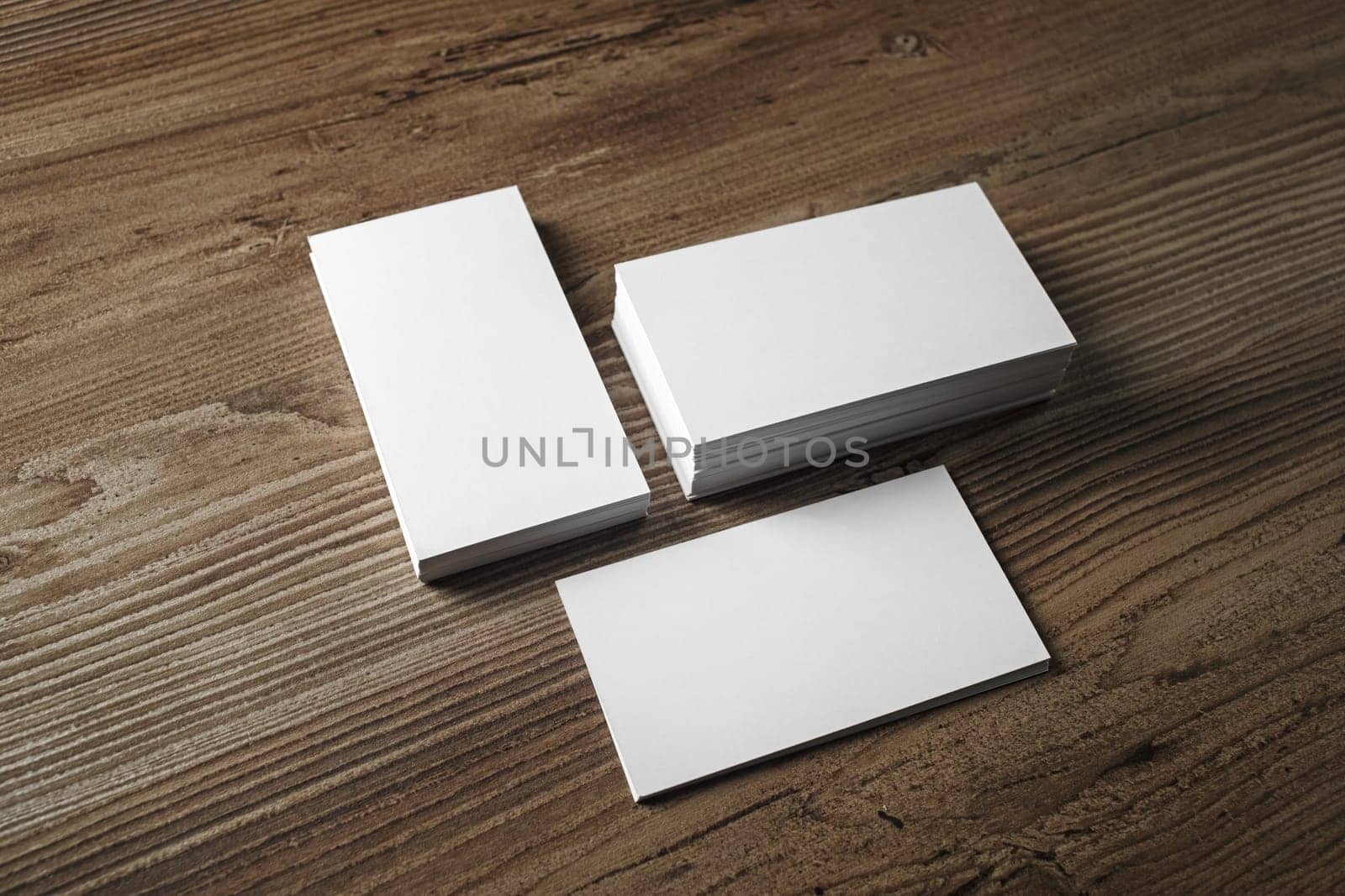 Photo of blank business cards on vintage wood table background. Mock up for ID. Blank template for branding identity.