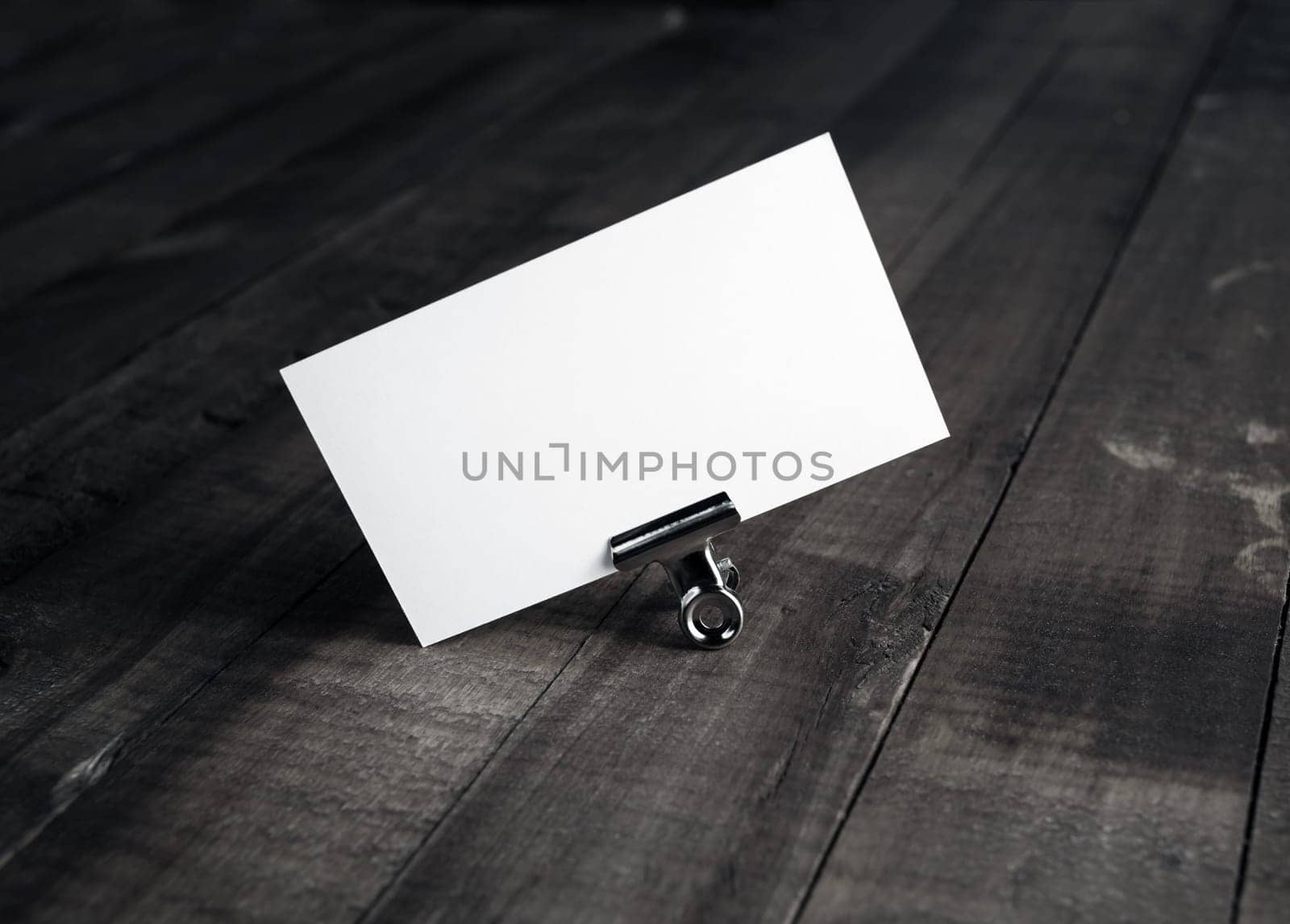 Photo of blank white bussiness card on wood background. Mockup for ID. Template for promotion of corporate identity. Blank name card.