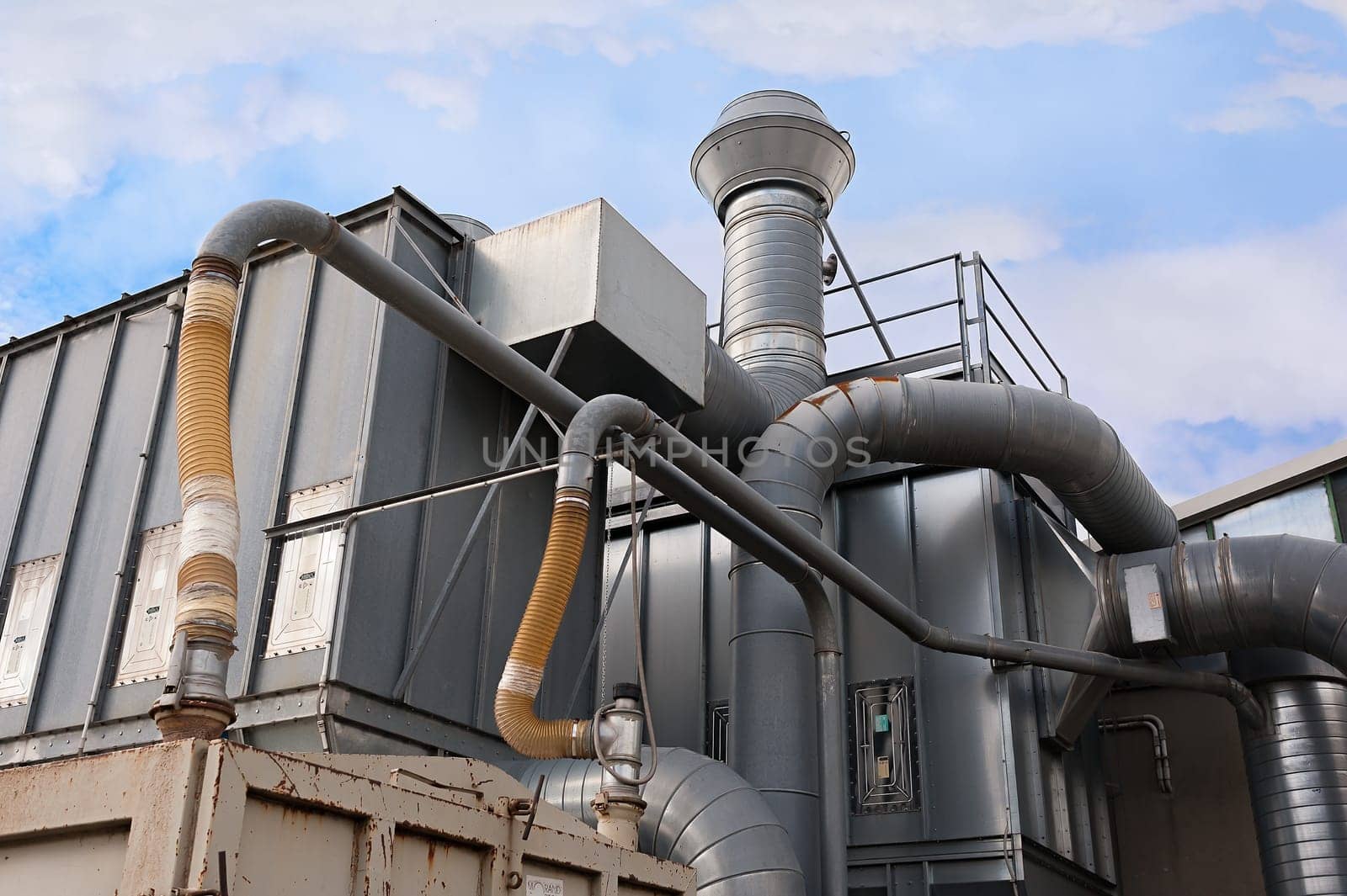 Industrial factory air filtration system. Tubes, tank and chimney.