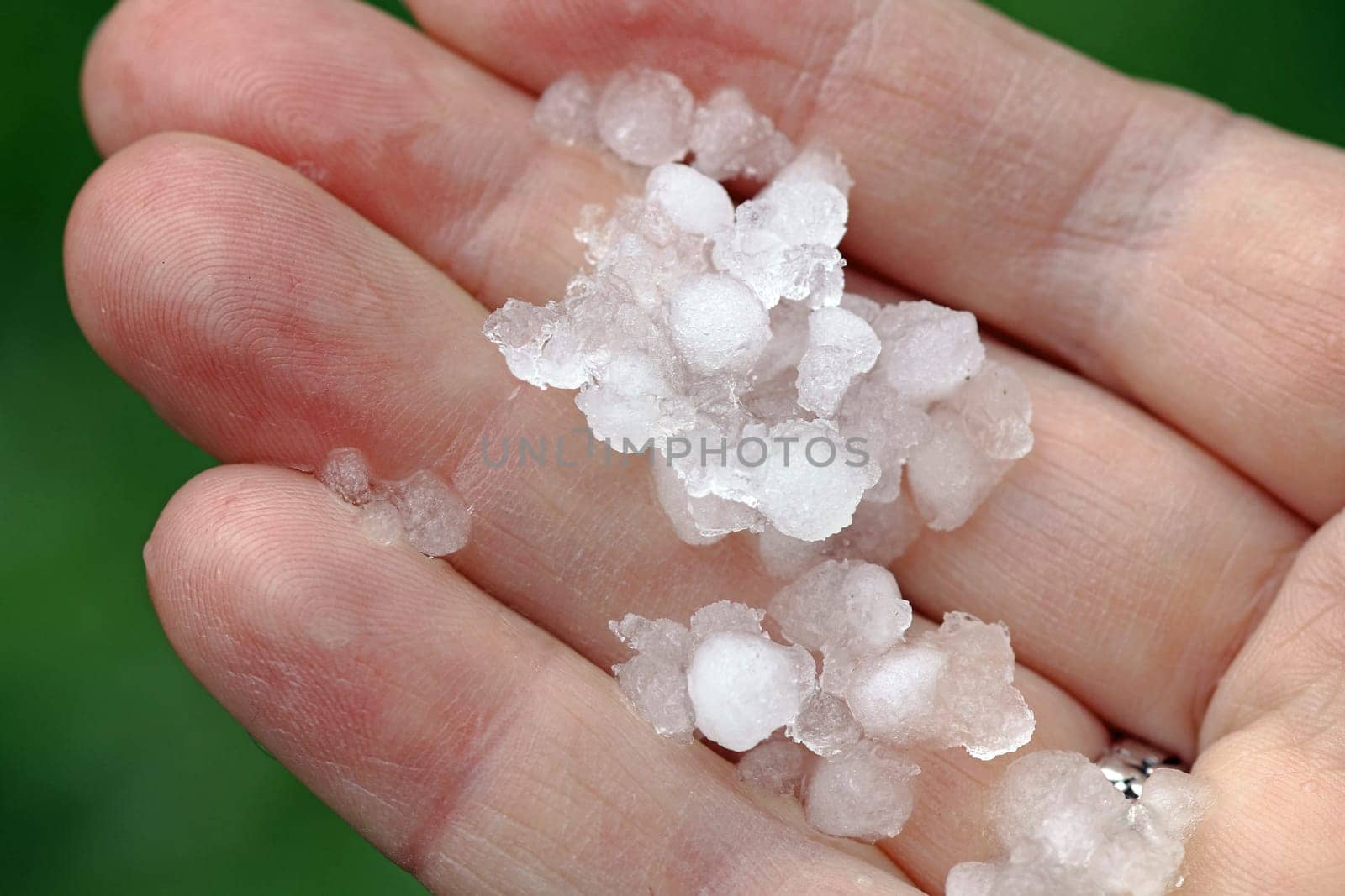Hailstones and sleet on a woman's hand