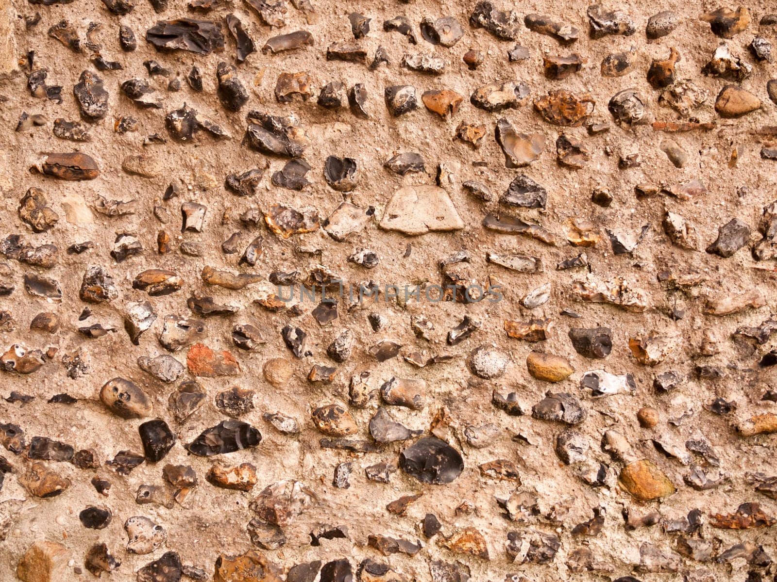 beautiful brick wall of cobble outside of church on cloudy day