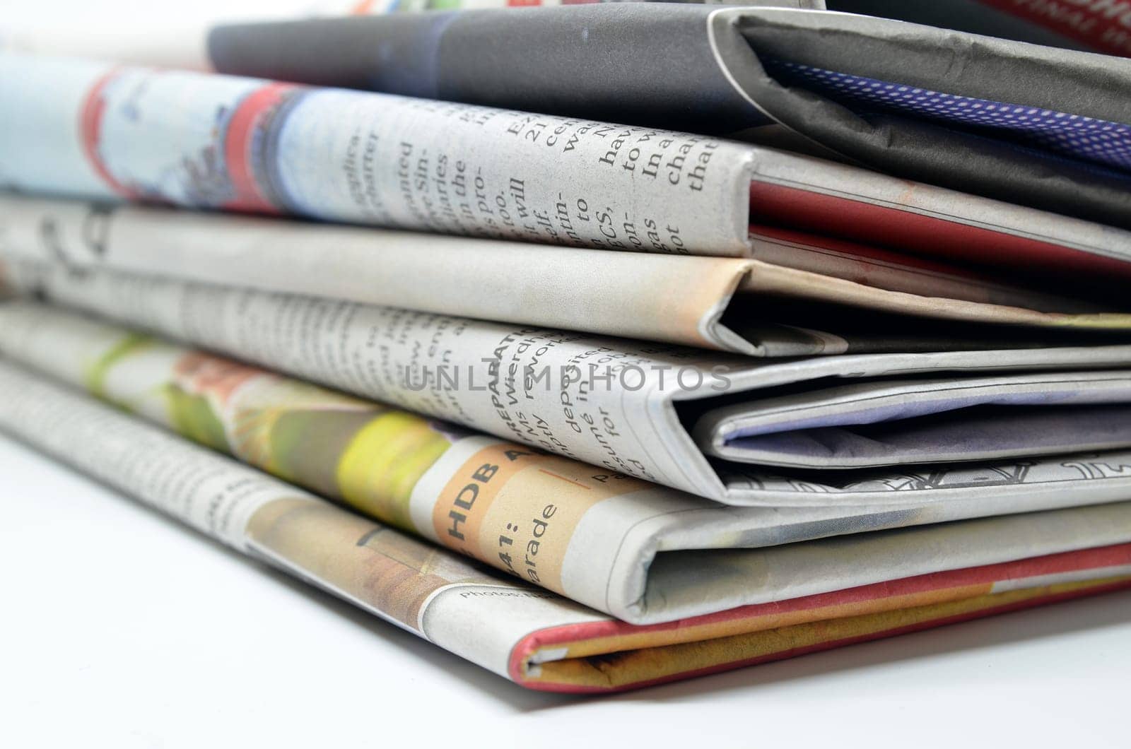 Newspapers folded and stacked isolated on white