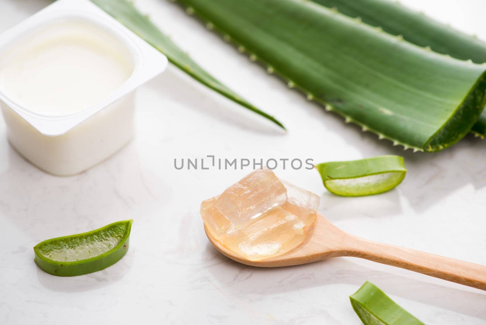 Aloe vera yogurt with fresh leaves on a wooden table