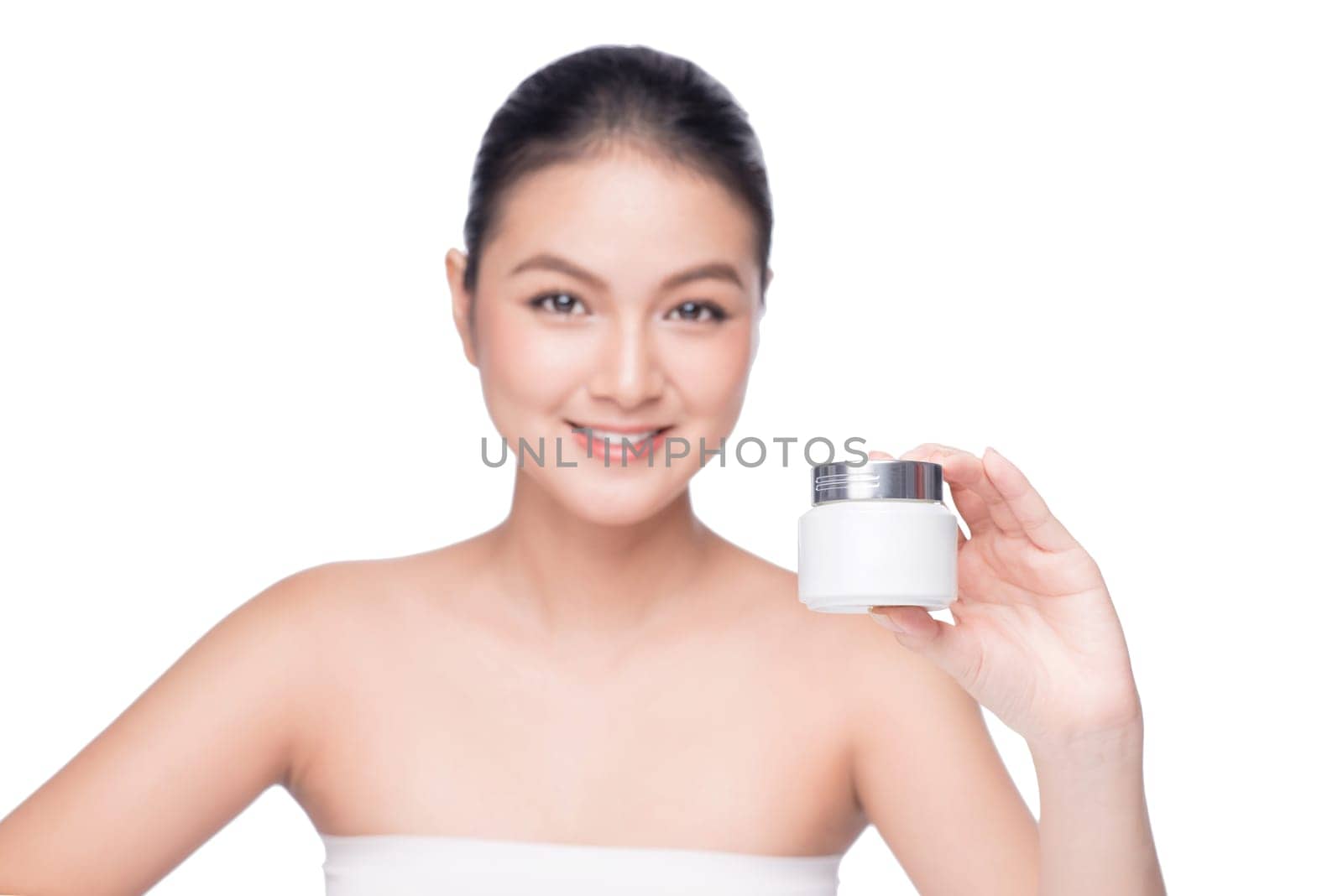Beauty treatment. Asian woman holding moisturizing cream box.