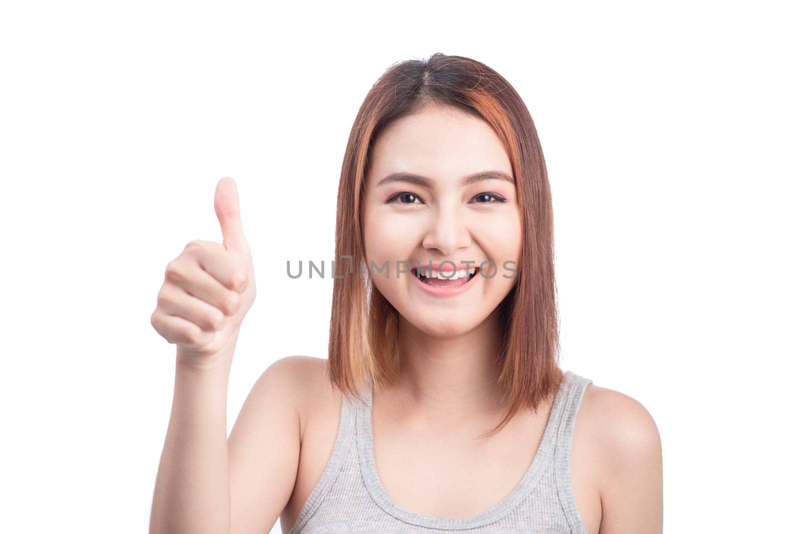 Cheerful lovely girl looking at camera showing thumbs up over white background.