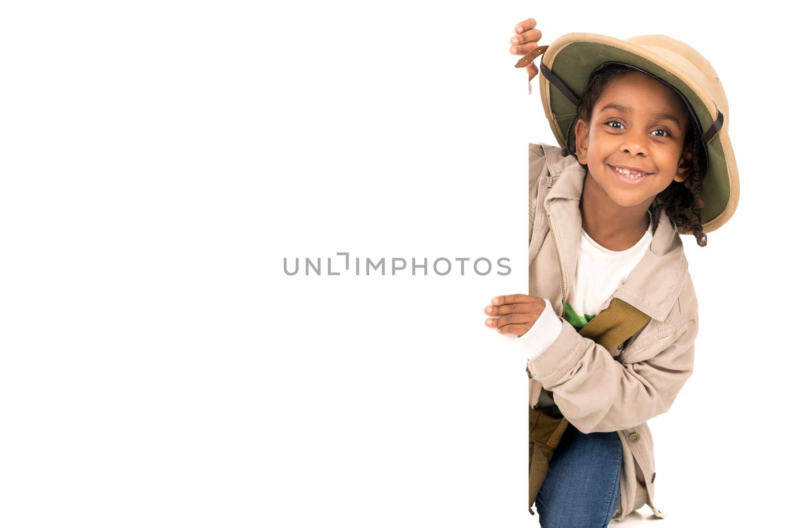 Young girl with Safari clothes behind a white board isolated in white